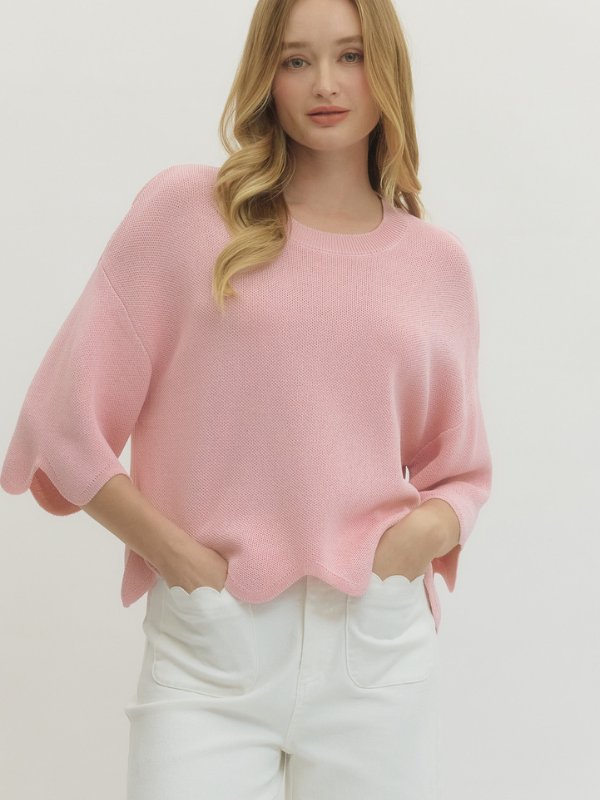 woman wearing light pink scalloped hem top 