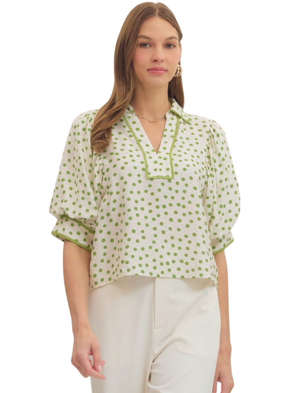 Woman wearing a green and white patterned blouse on a white background