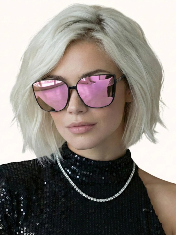 Person with short blonde hair wearing pink-lensed sunglasses and a black sequin outfit.