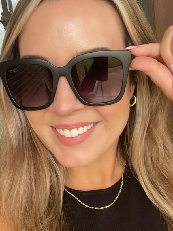 woman wearing black framed sunglasses with black lenses