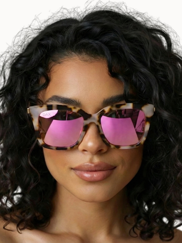 woman wearing sunglasses with pink lenses and tortoise frames 