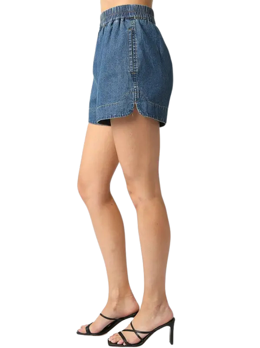 Denim shorts worn by a person on a white background