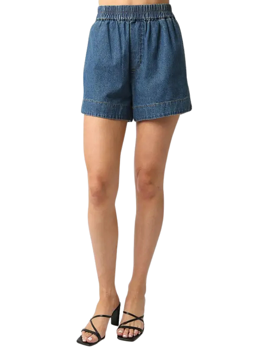 Blue denim shorts worn by a person on a white background