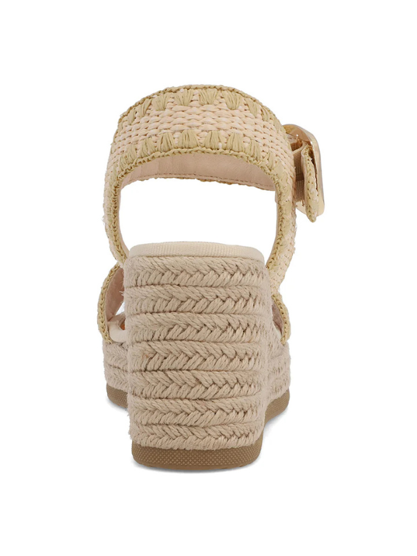 Beige wedge sandal with braided design on a white background
