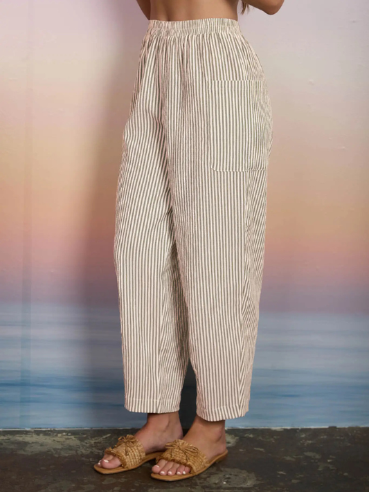Person wearing striped pants with a blurred background