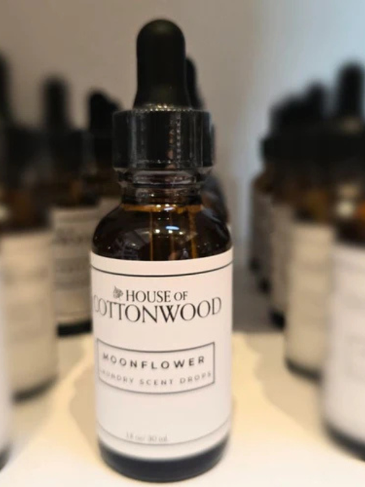 Bottle of 'House of Cottonwood' Moonflower product on a white surface with blurred background