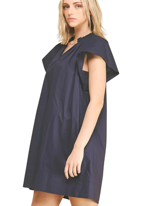 Woman wearing a navy blue dress on a white background