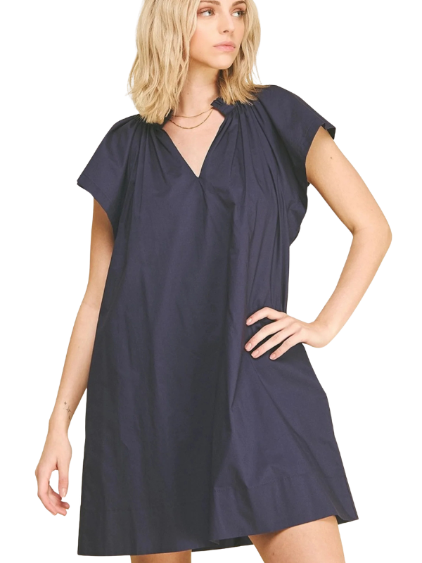 Woman wearing a navy blue dress on a white background