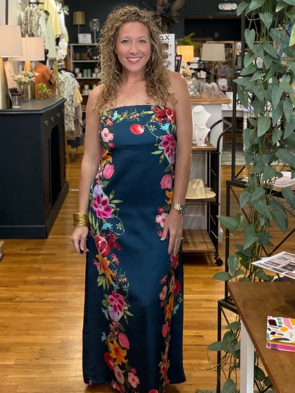 Woman wearing a floral strapless dress in a store setting
