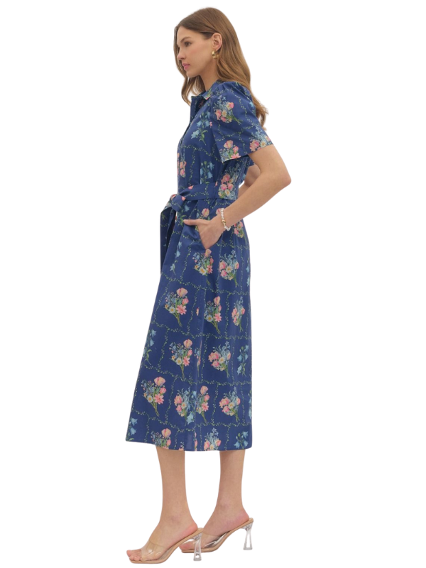 Woman wearing a blue floral dress on a white background