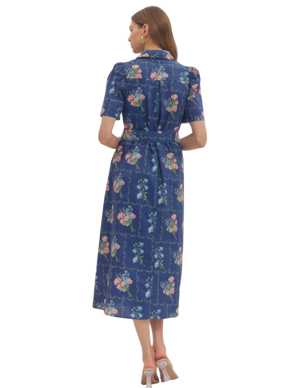 Woman wearing a blue floral dress on a white background