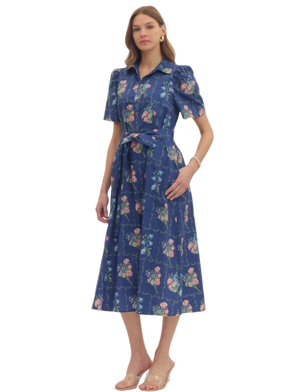 Woman wearing a blue floral dress on a white background