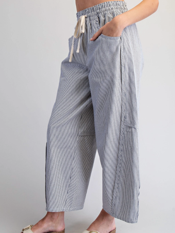 Striped wide-leg pants worn by a person on a plain background