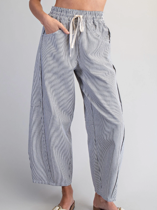 Striped pants worn by a person on a plain background