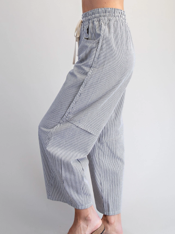 Striped pants worn by a person on a plain background