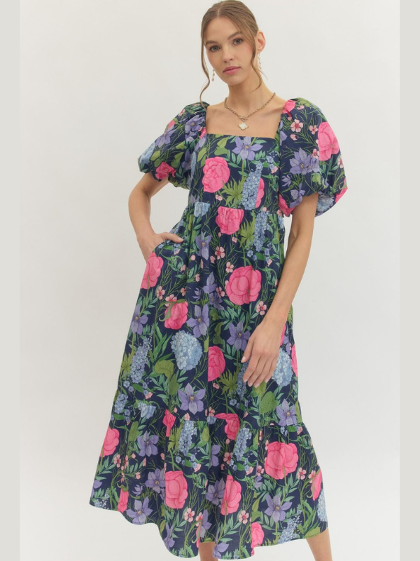 Woman wearing a floral dress with puff sleeves on a white background