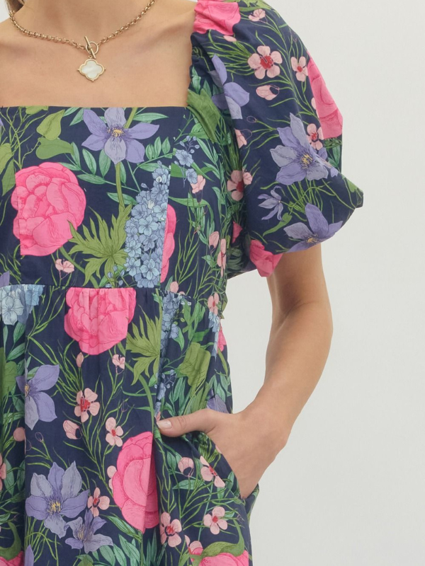 Woman wearing a floral dress with a plain background