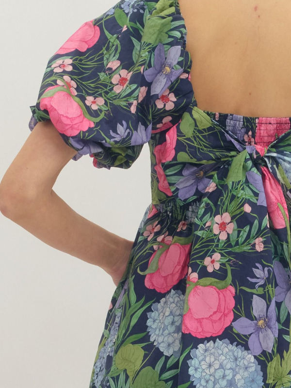 Floral dress with pink and purple flowers on a white background