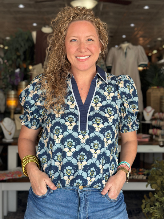 Woman wearing a patterned shirt in a store setting