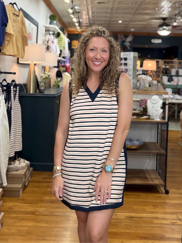Woman wearing a striped dress in a store setting