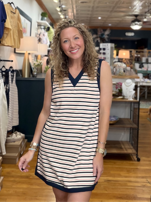 Woman wearing a striped dress in a store setting