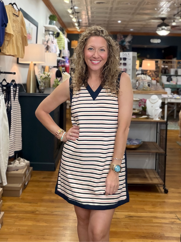Woman wearing a striped dress in a store setting
