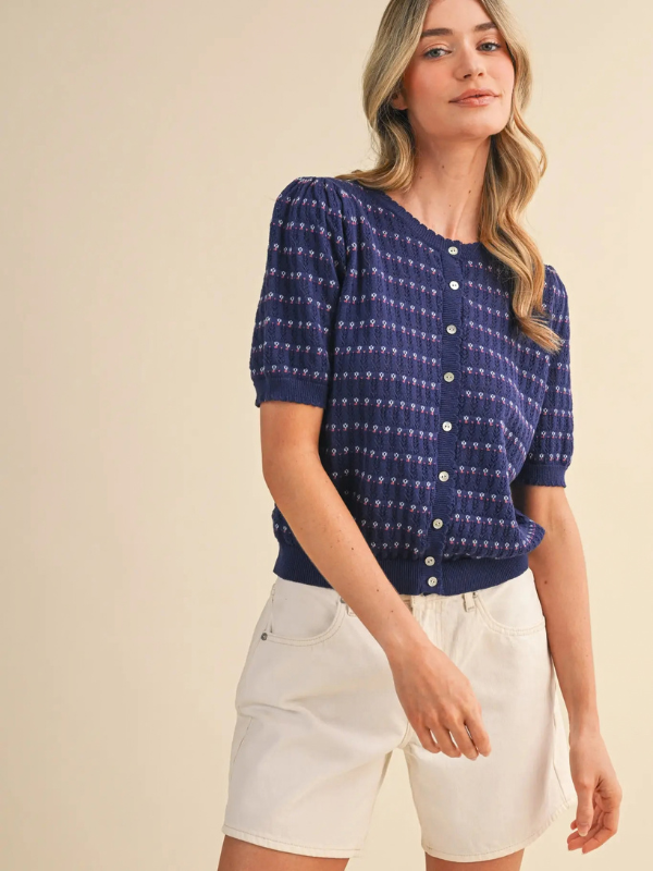 woman wearing a navy pointelle button sweater 