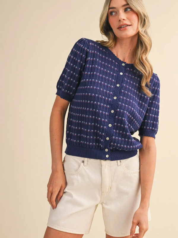 woman wearing a navy pointelle button sweater 