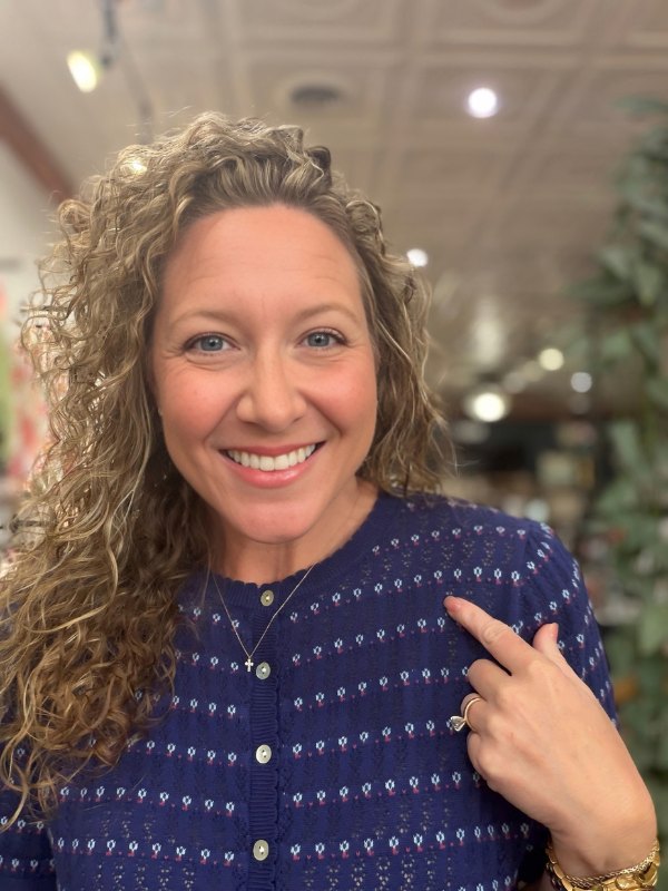 woman wearing a navy pointelle button sweater 