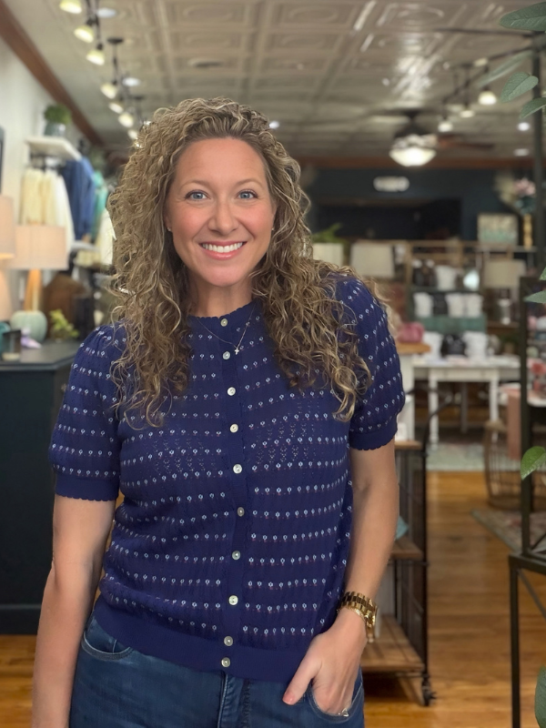 woman wearing a navy pointelle button sweater 
