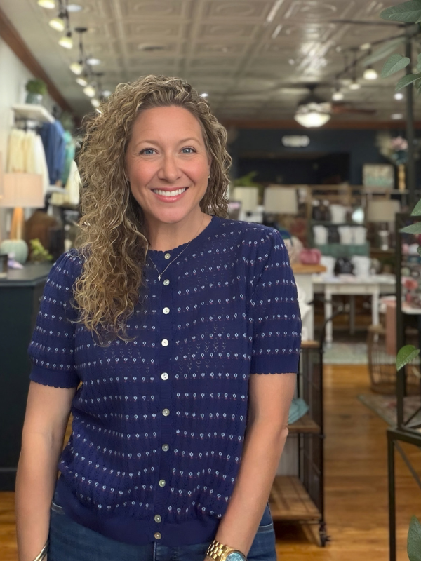 woman wearing a navy pointelle button sweater 