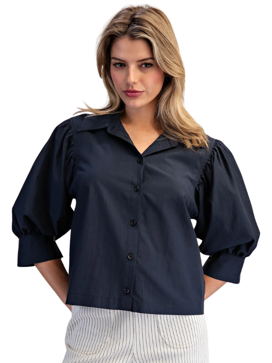 woman wearing navy puff sleeve top 