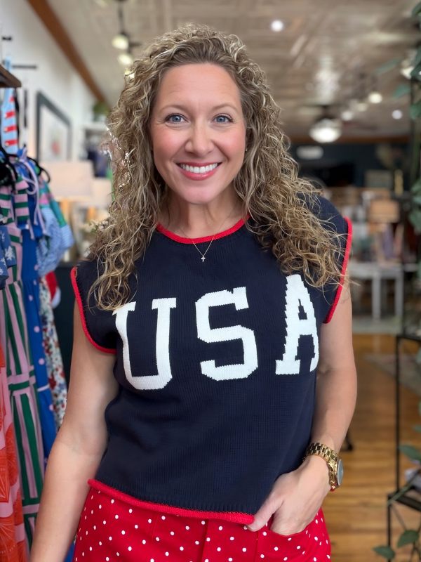 Woman wearing a black 'USA' shirt in a store setting