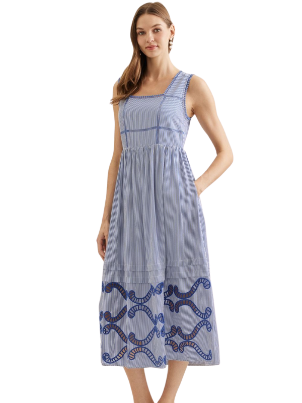 Woman wearing a blue dress with a white background