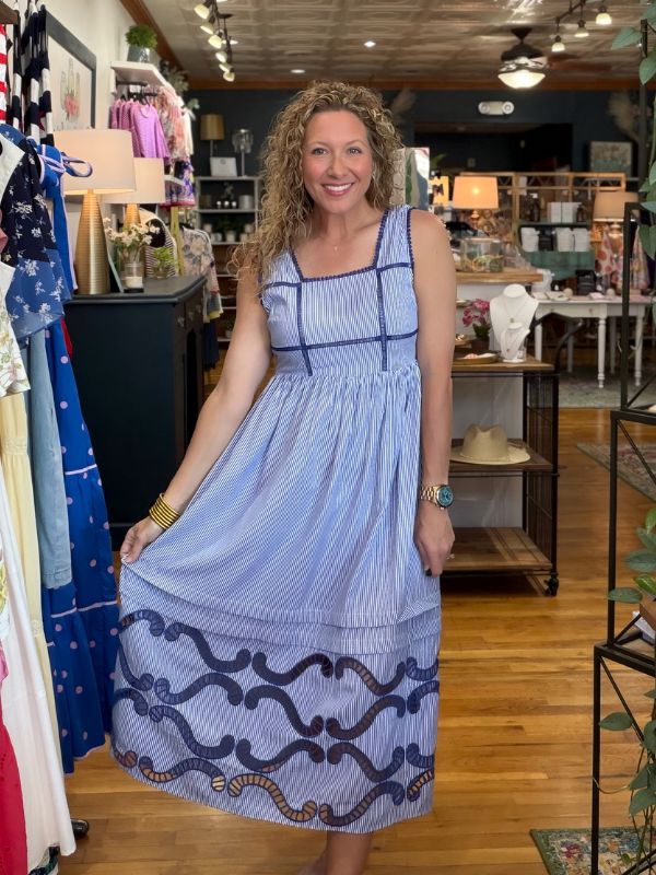 Woman wearing a blue dress in a store setting