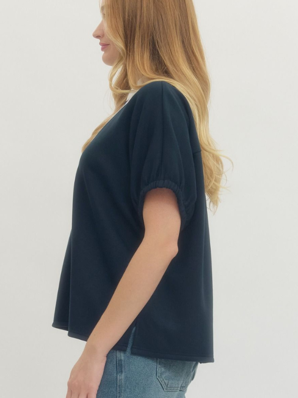 Woman wearing a dark blue t-shirt and jeans on a white background