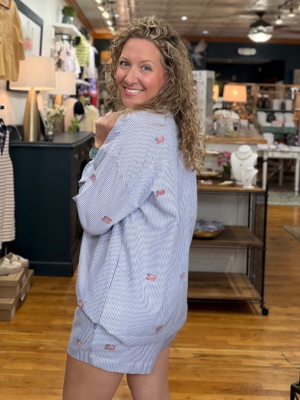Woman wearing a blue checkered outfit in a store setting