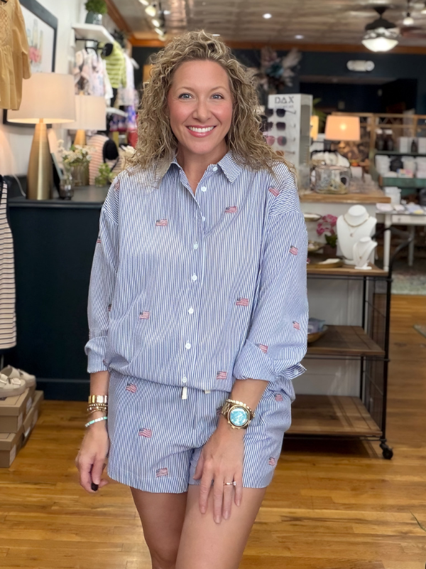 Woman wearing a blue striped outfit in a store setting