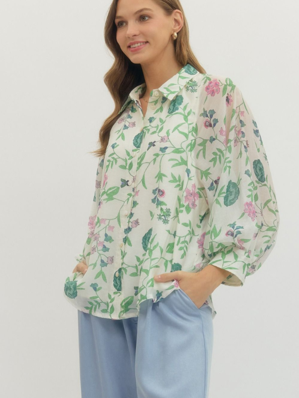 Woman wearing a floral blouse with a plain background