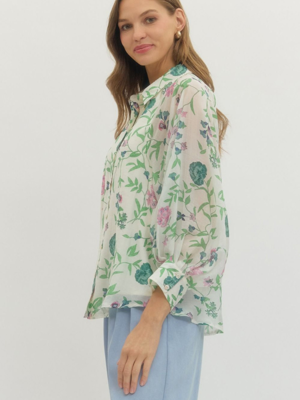 Woman wearing a floral blouse with a plain background
