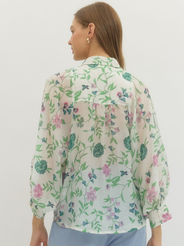 Woman wearing a floral blouse with a white background