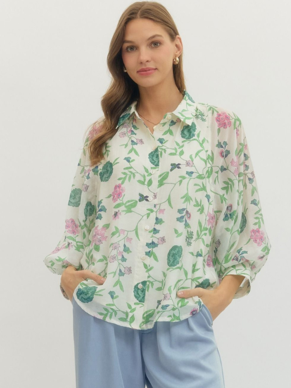 Woman wearing a floral blouse with a plain background