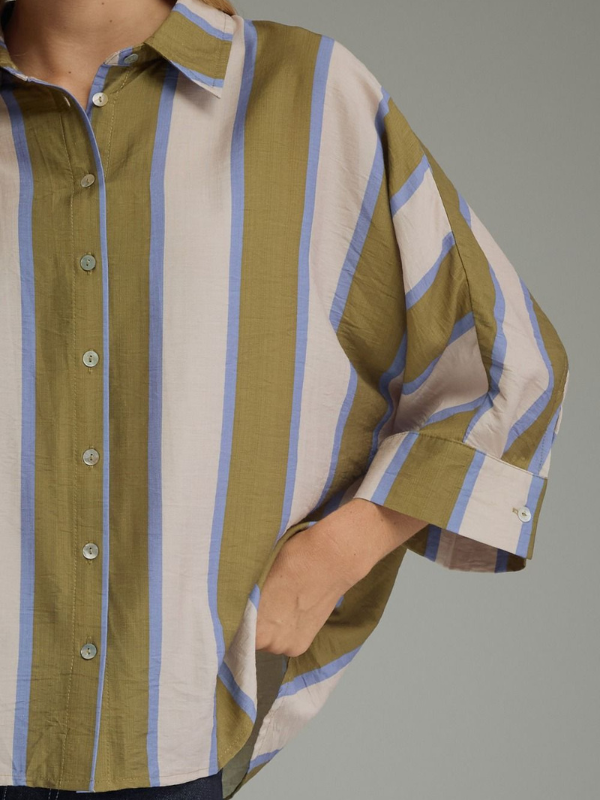 woman wearing an olive and blue striped button up top 