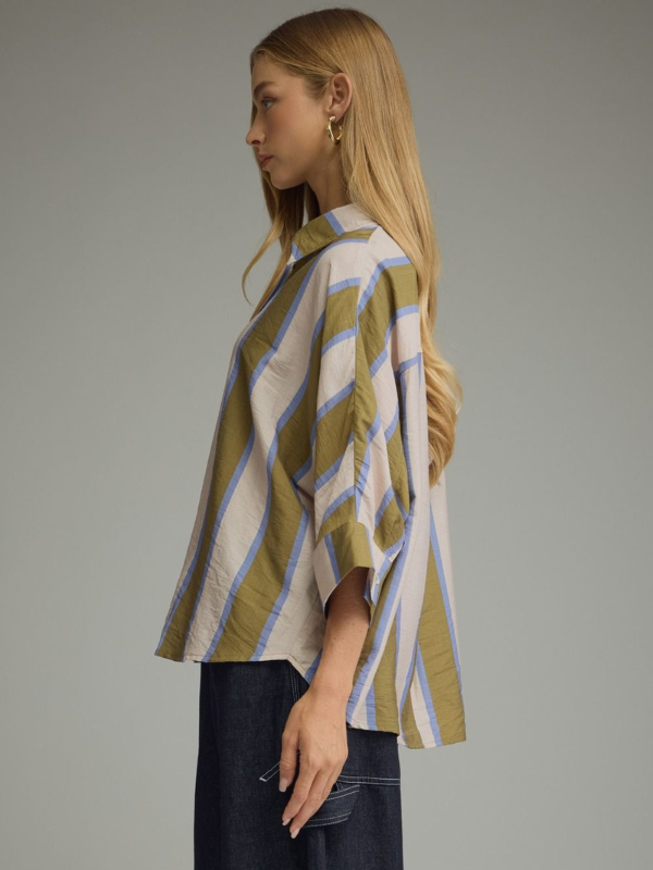 woman wearing an olive and blue striped button up top 