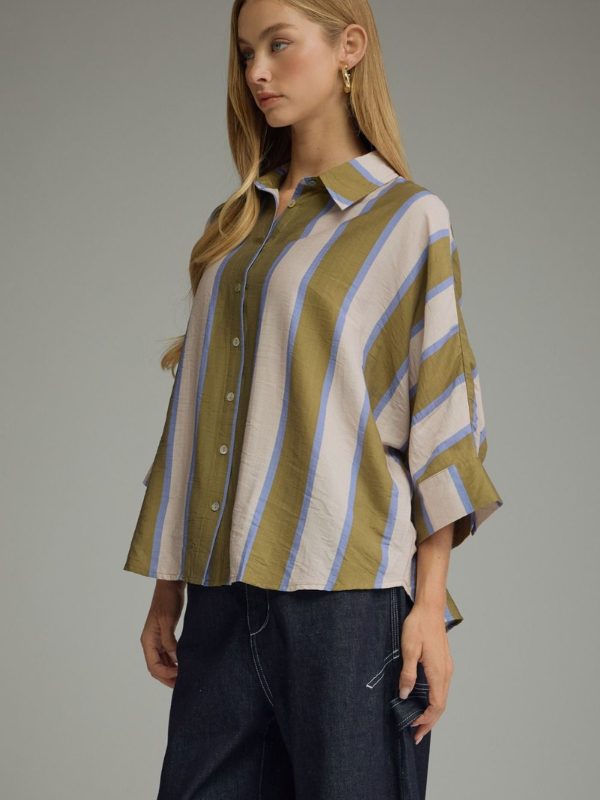woman wearing an olive and blue striped button up top 