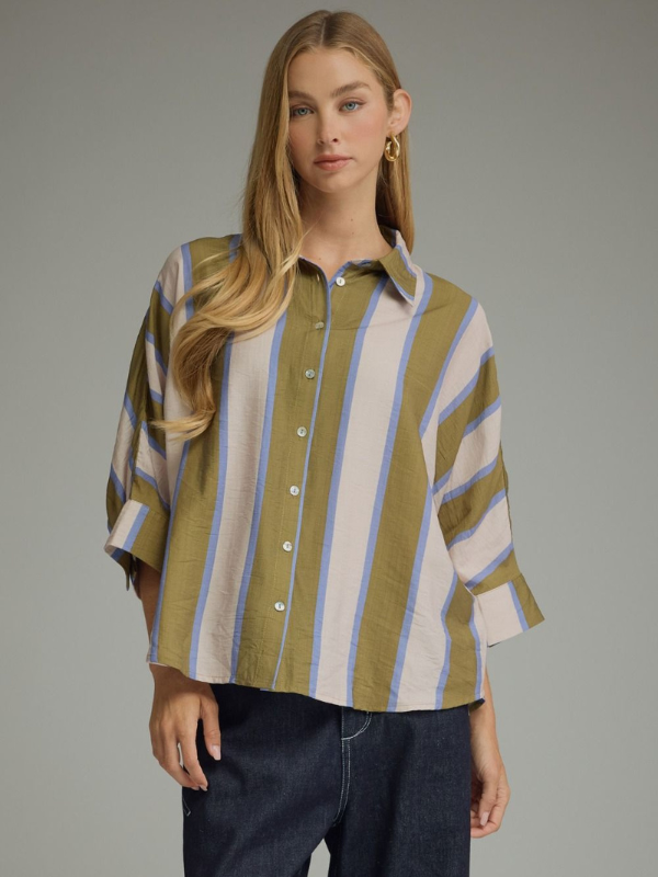 woman wearing an olive and blue striped button up top 