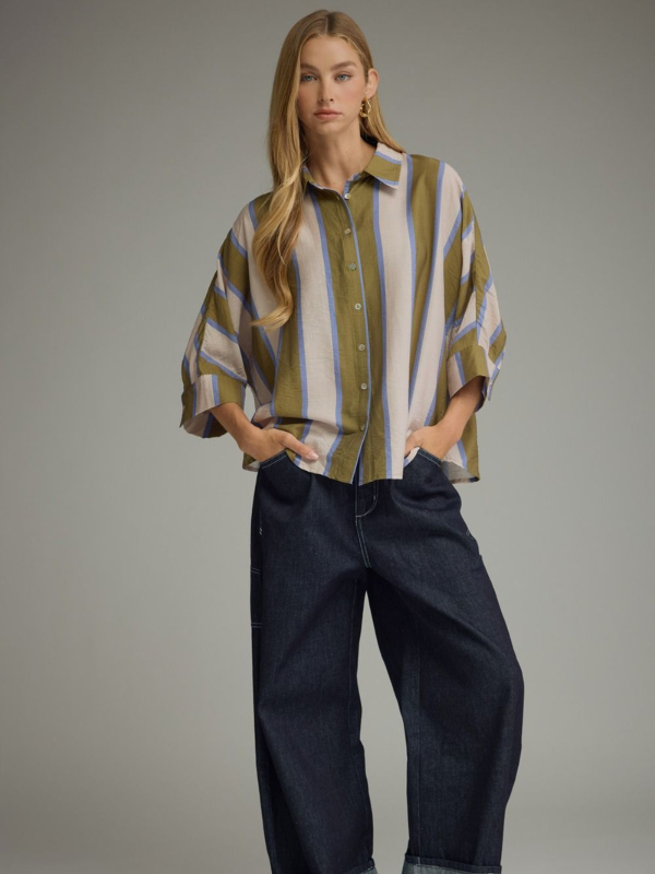 woman wearing an olive and blue striped button up top 