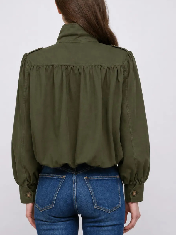 woman wearing an olive green bomber jacket and jeans