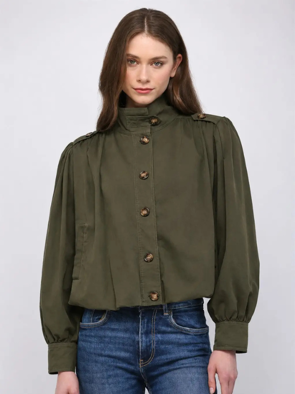 woman wearing an olive green bomber jacket and jeans