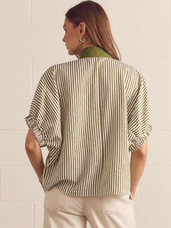 Person wearing a striped shirt with a neutral background